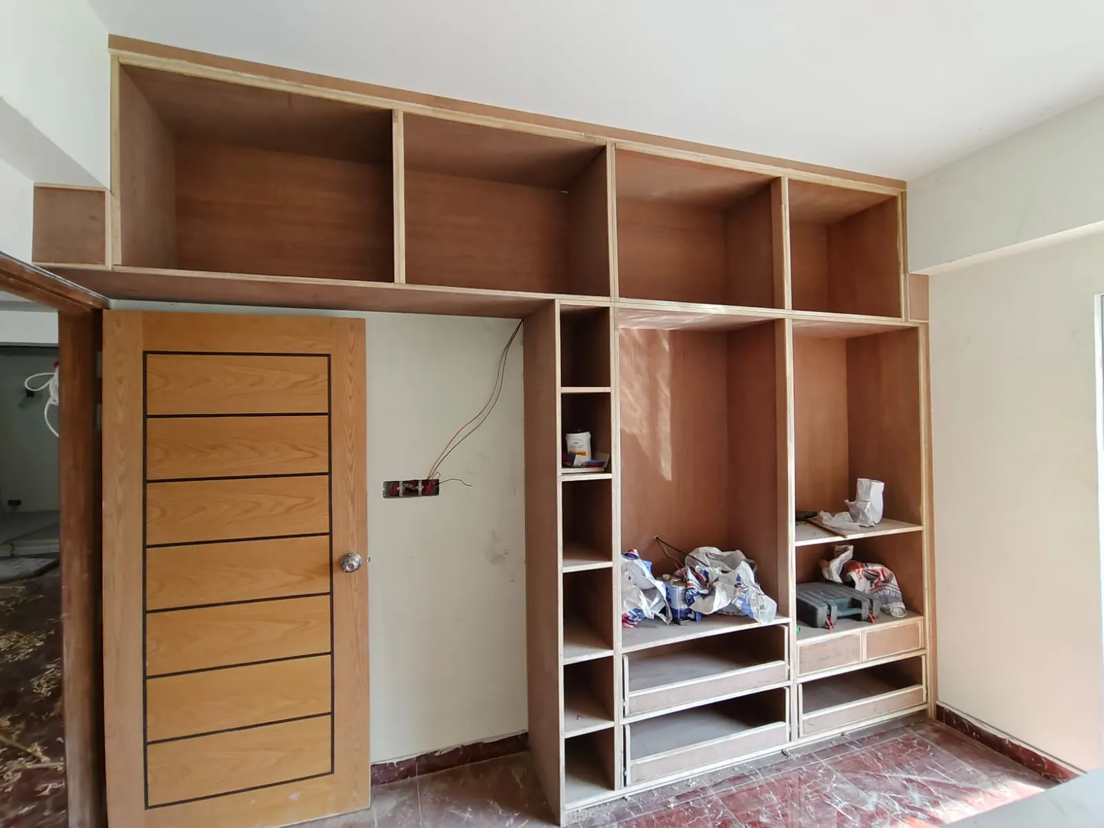 unfinished-wooden-wardrobe-installed-in-bedroom